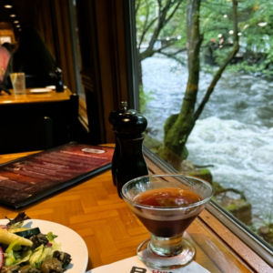 Dining table beside the river at The Peddler Steakhouse in Gatlinburg